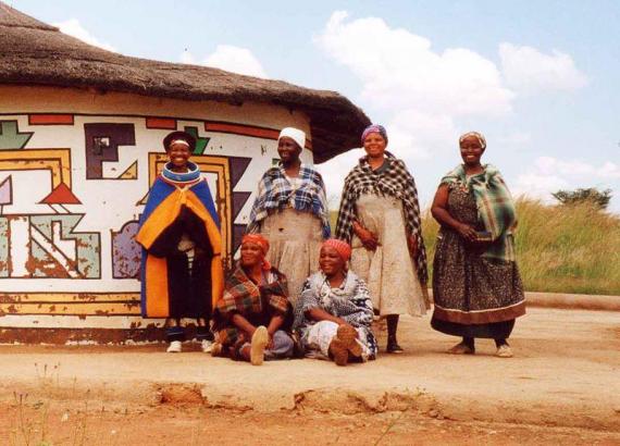 The women of Loopspruit Cultural Village, near Bronkhorstpruit, in front of a tradionally-painted Ndeble dwelling